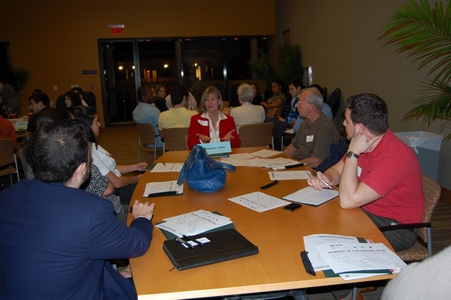 Event co-chair from CREW, Ellen Blasi, director of leasing, The Green Companies, in red at the head of the table