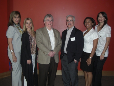 Staff of the business school with two members of the MIT Venture Mentoring Service