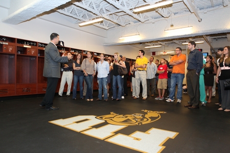 Head FIU football coach Mario Cristobal with a group of Golden Panthers fans, guests of Padron