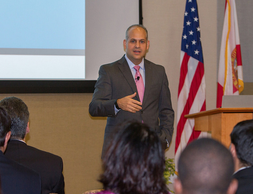 Acting College of Business Dean Jose Aldrich presents Wertheim Lecture recognition to John Zamora.