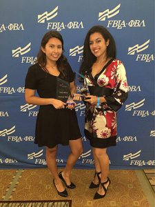 Madeleine Rabi and Marisel Lavizzari proudly displaying their award.