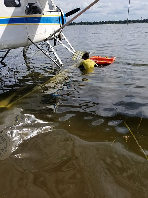 A Miami Seaplane Tours plane being salvaged after it was pushed in the water by Hurricane Irma