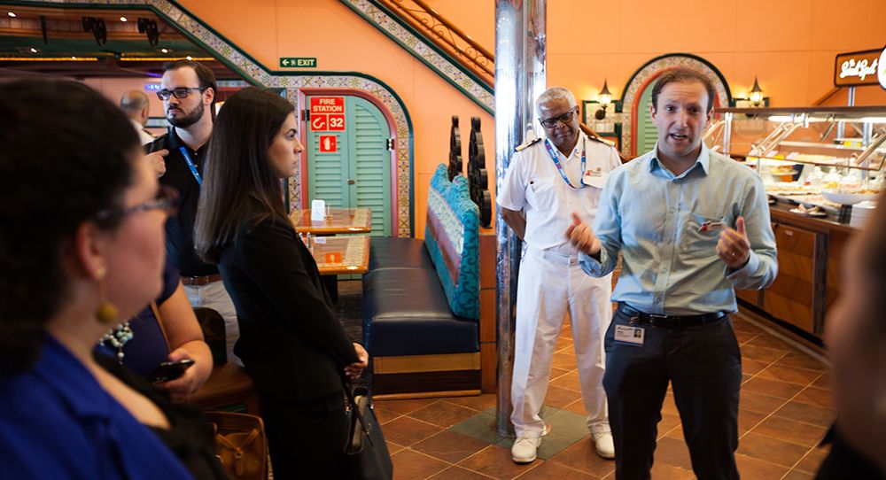 Adrian Greystoke, Carnival Cruise Line’s vice president, operational shared services, welcomes FIU Business students at the buffet. 